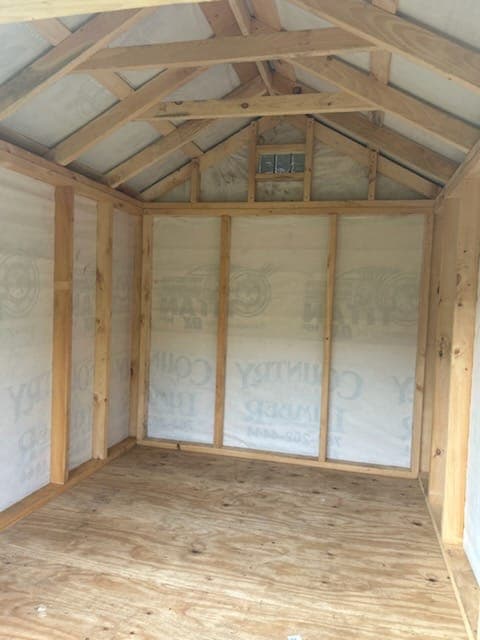 Exterior view of a storage shed with the door open